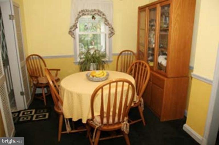 4119 Raleigh Road Pikesville, MD 21208 - Photo 7 of 15 a dining room with furniture and wooden floor