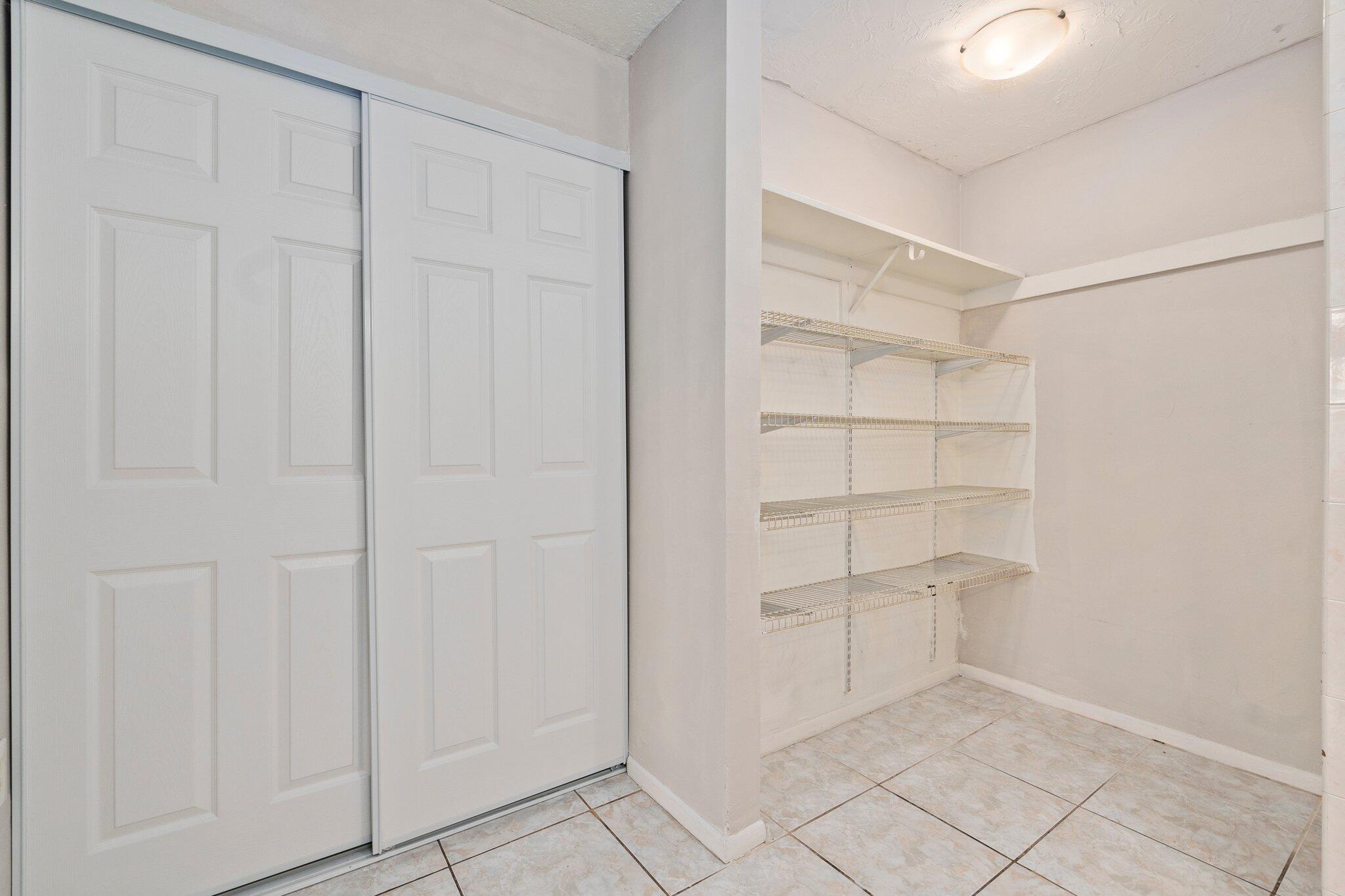 6012 Indrio Road, Unit E2 Fort Pierce, FL 34951 - Photo 16 of 25 a view of a room with rack on the wall