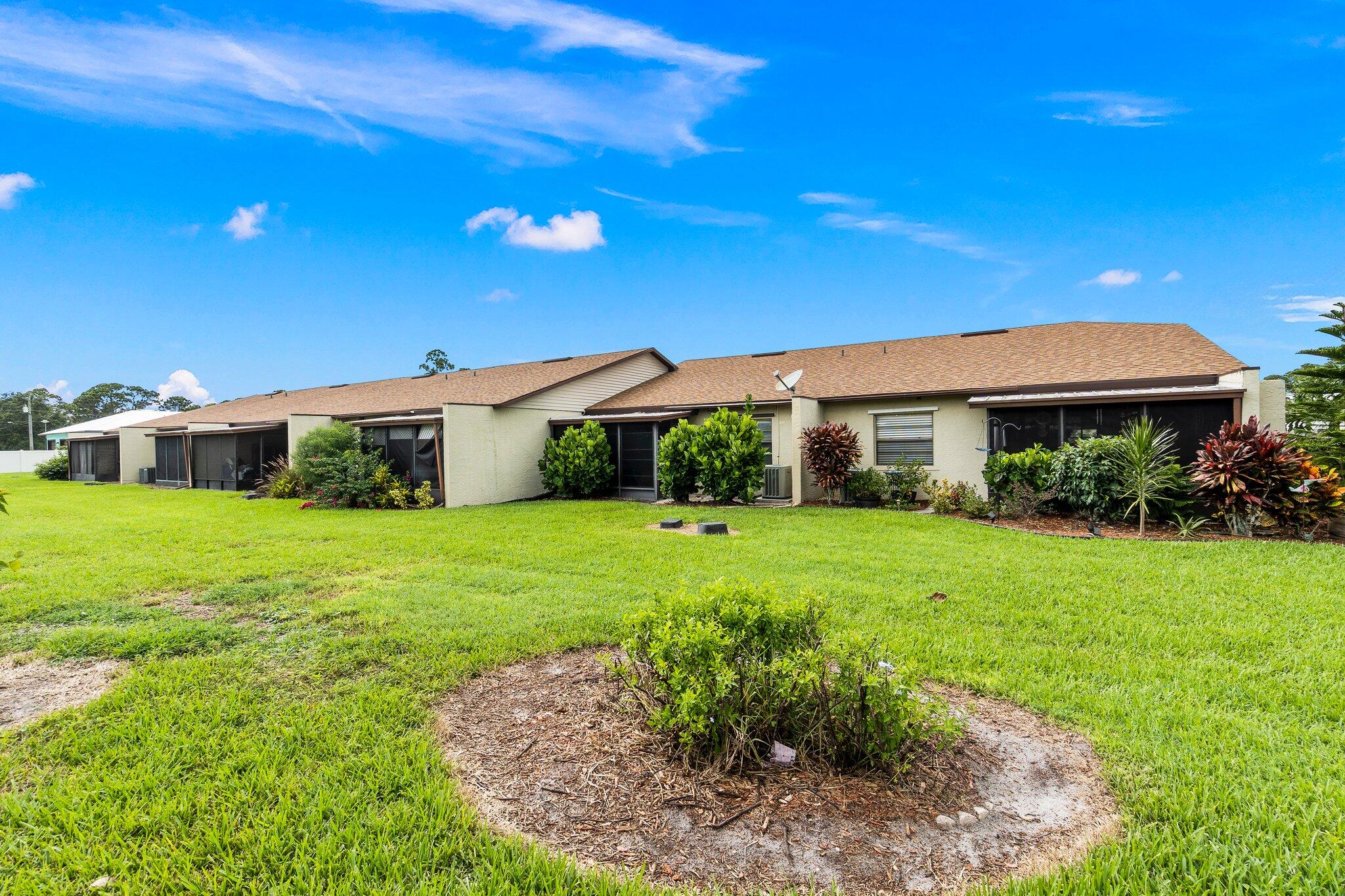 6012 Indrio Road, Unit E2 Fort Pierce, FL 34951 - Photo 24 of 25 a front view of house with yard and green space