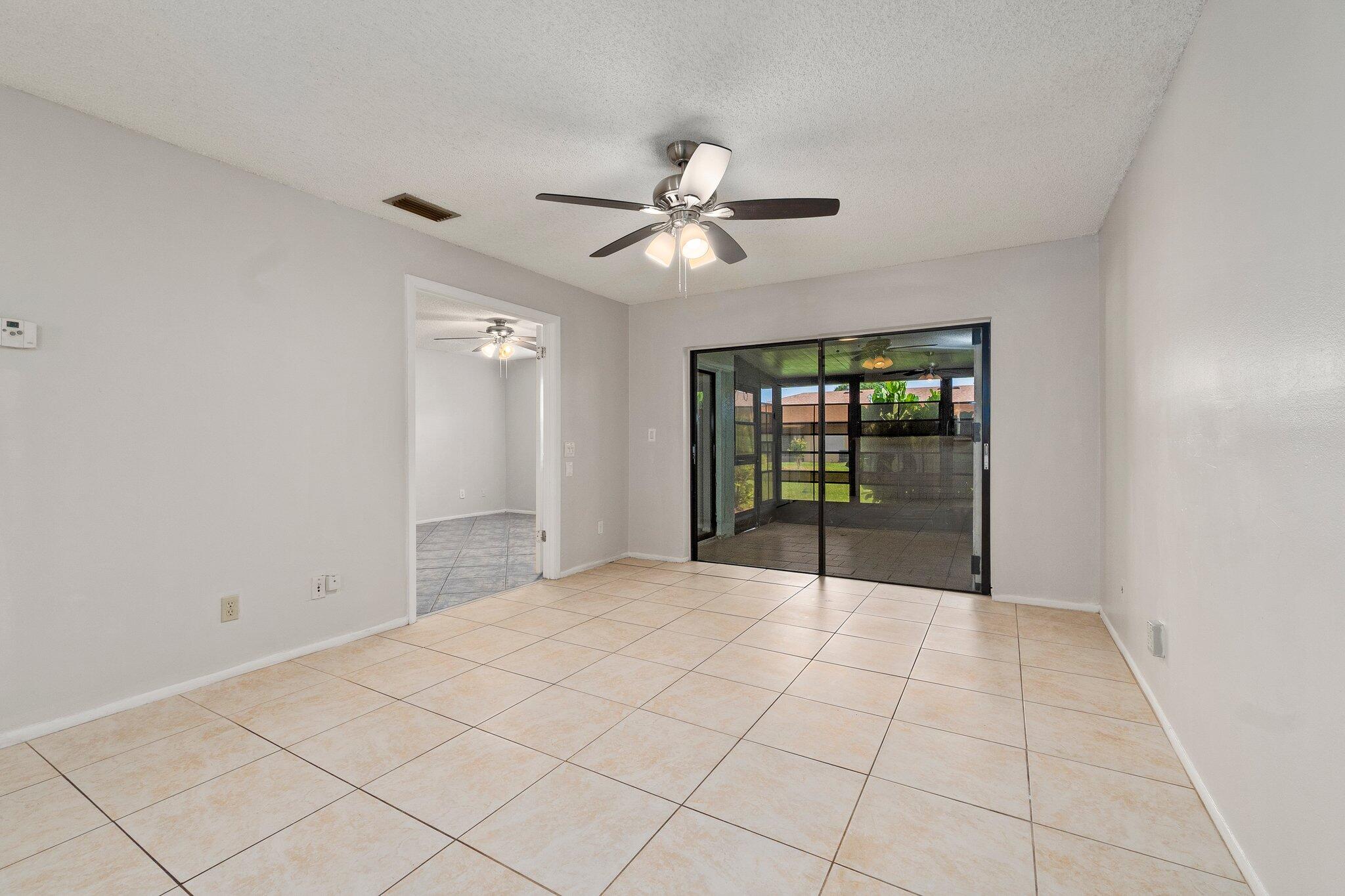 6012 Indrio Road, Unit E2 Fort Pierce, FL 34951 - Photo 6 of 25 a very nice looking room with a ceiling fan