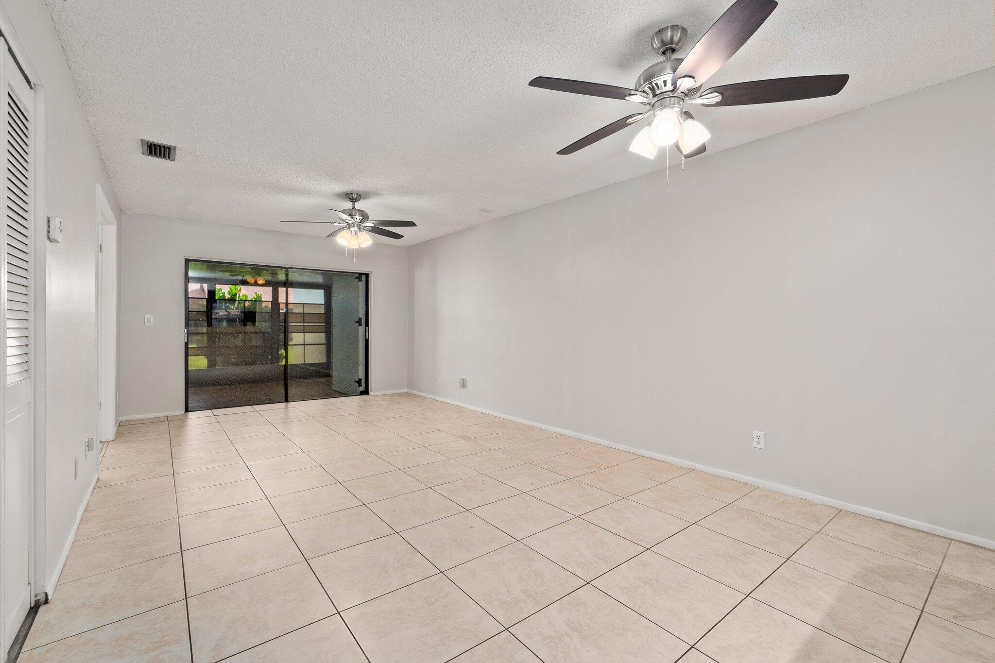 6012 Indrio Road, Unit E2 Fort Pierce, FL 34951 - Photo 7 of 25 a view of an empty room with a window