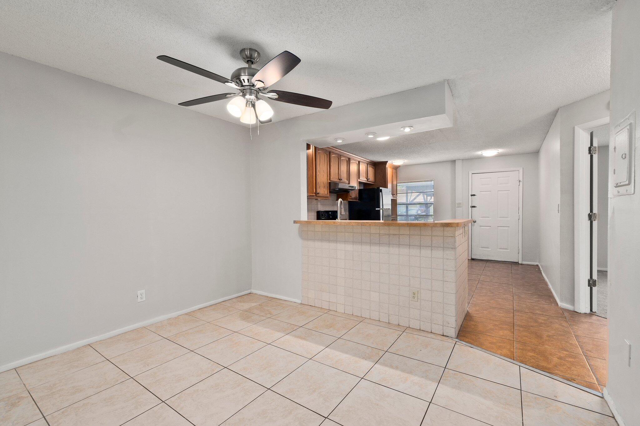 6012 Indrio Road, Unit E2 Fort Pierce, FL 34951 - Photo 9 of 25 a view of a kitchen with a sink and a window