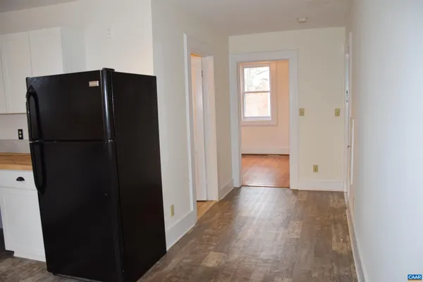 a view of hallway with wooden floor