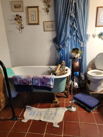 a bed sitting in a bedroom next to a lamp