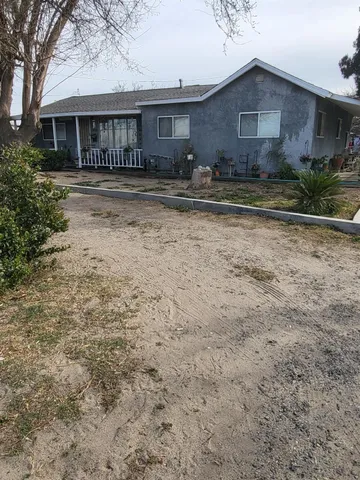 a view of a house with a yard next to a road