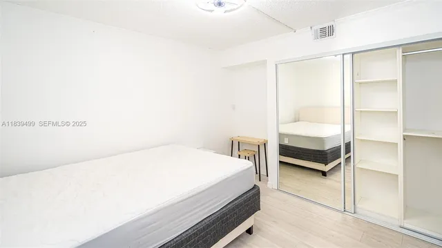 a bedroom with a bed and a table