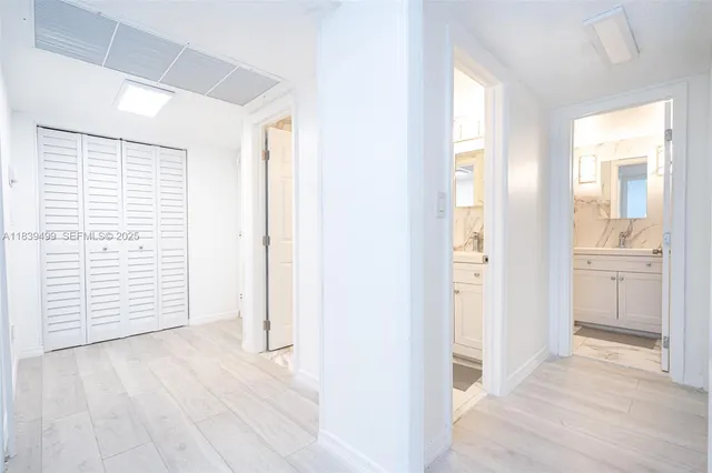 a view of a room with wooden floor and windows