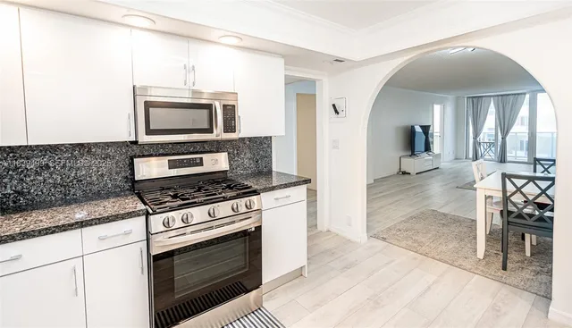 a kitchen with a stove a microwave and refrigerator