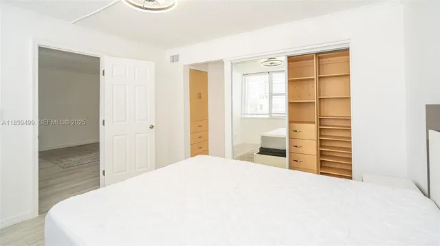 a bedroom with a bed and a cabinet