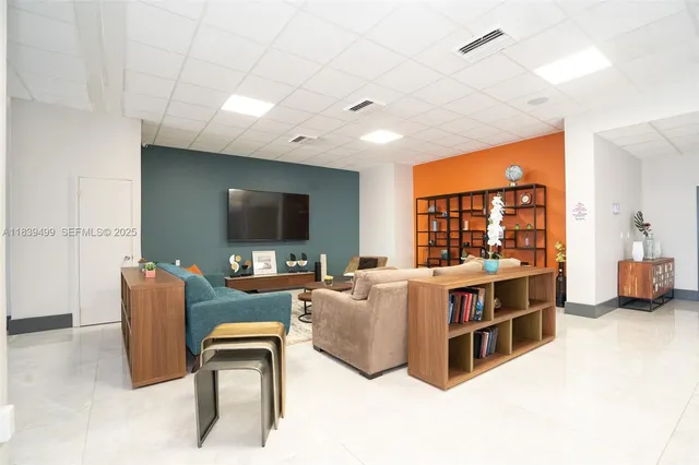 a living room with furniture and a large window