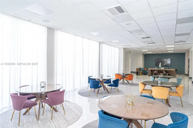a living room with furniture a pool table and a couch
