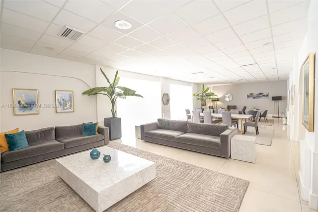 a living room with furniture a rug and a chandelier