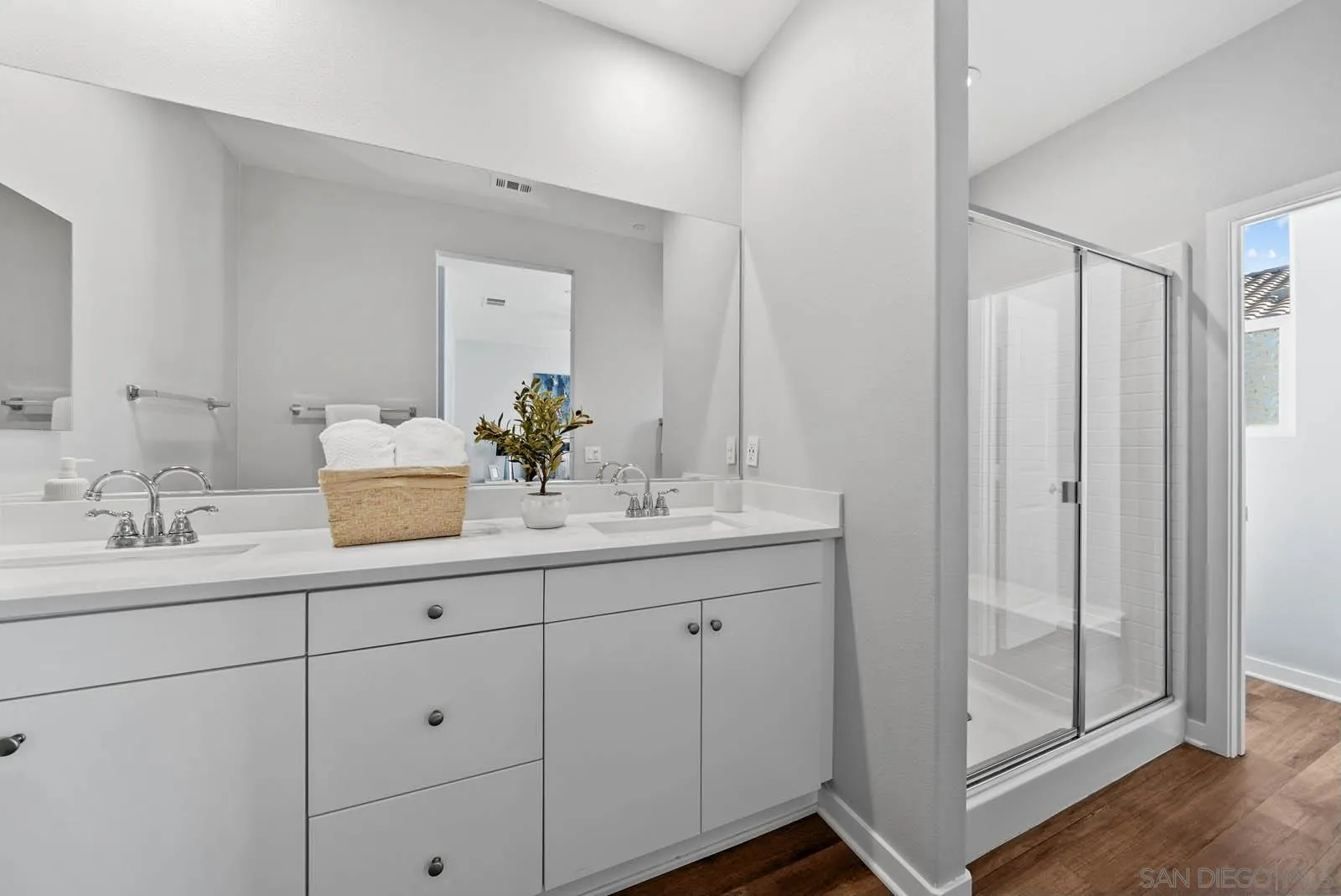 4132 Rio Azul Way Oceanside, CA 92057 - Photo 19 of 48 a bathroom with a double vanity sink and mirror