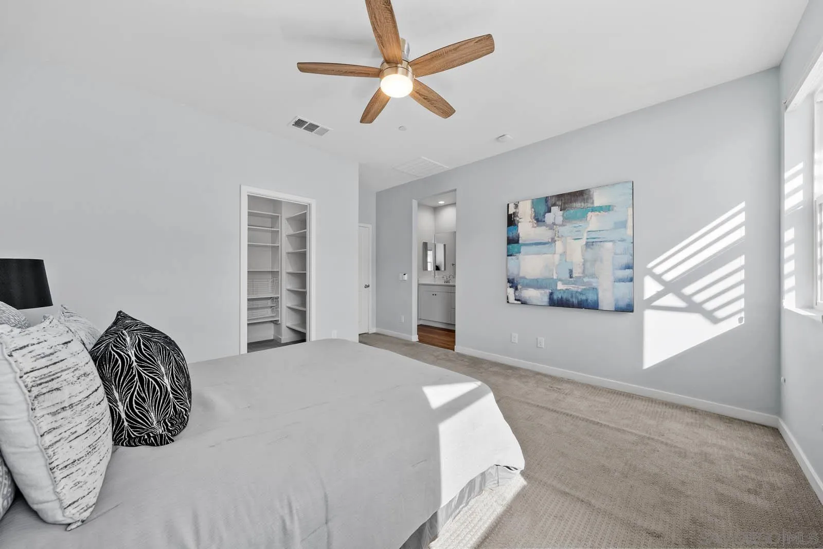 4132 Rio Azul Way Oceanside, CA 92057 - Photo 21 of 48 a bedroom with a bed a ceiling fan and a window