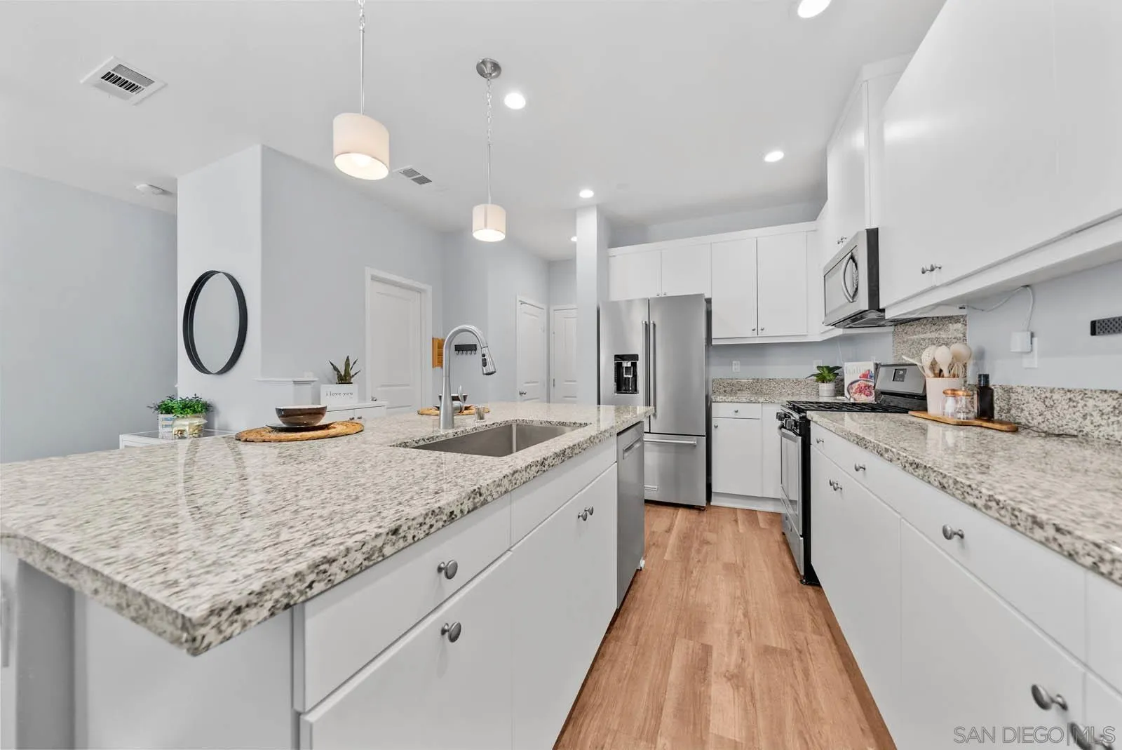4132 Rio Azul Way Oceanside, CA 92057 - Photo 6 of 48 a kitchen with sink stove and cabinets