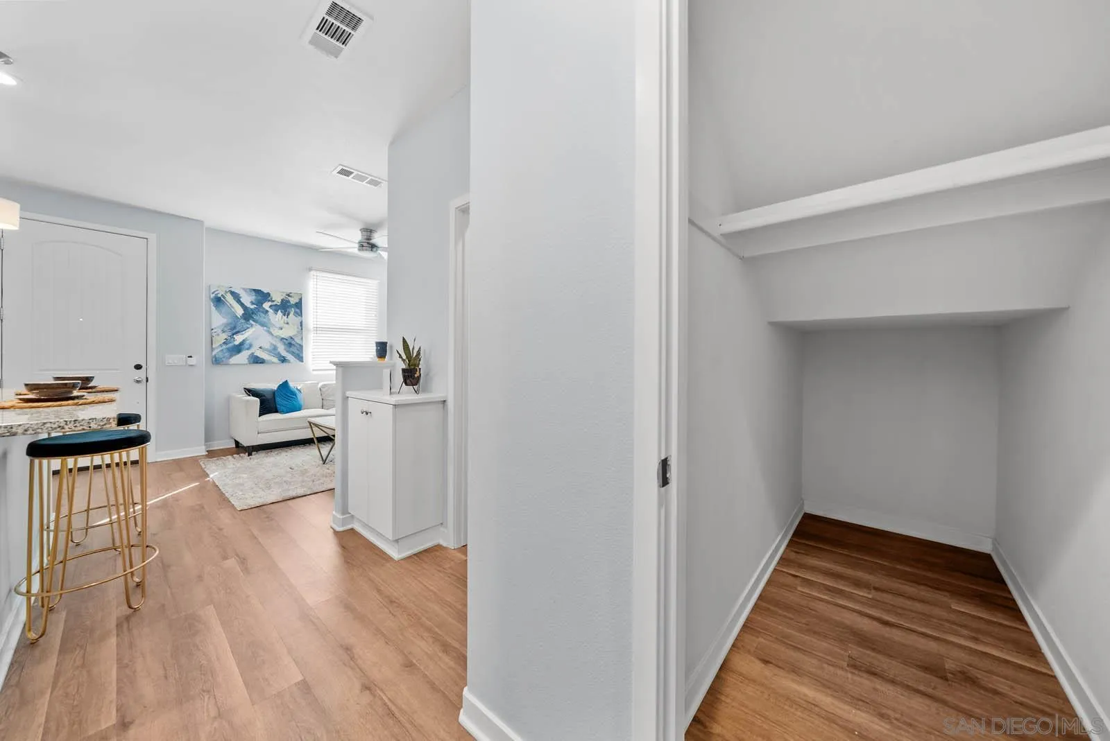 4132 Rio Azul Way Oceanside, CA 92057 - Photo 7 of 48 a hallway with wooden floor a bedroom and windows