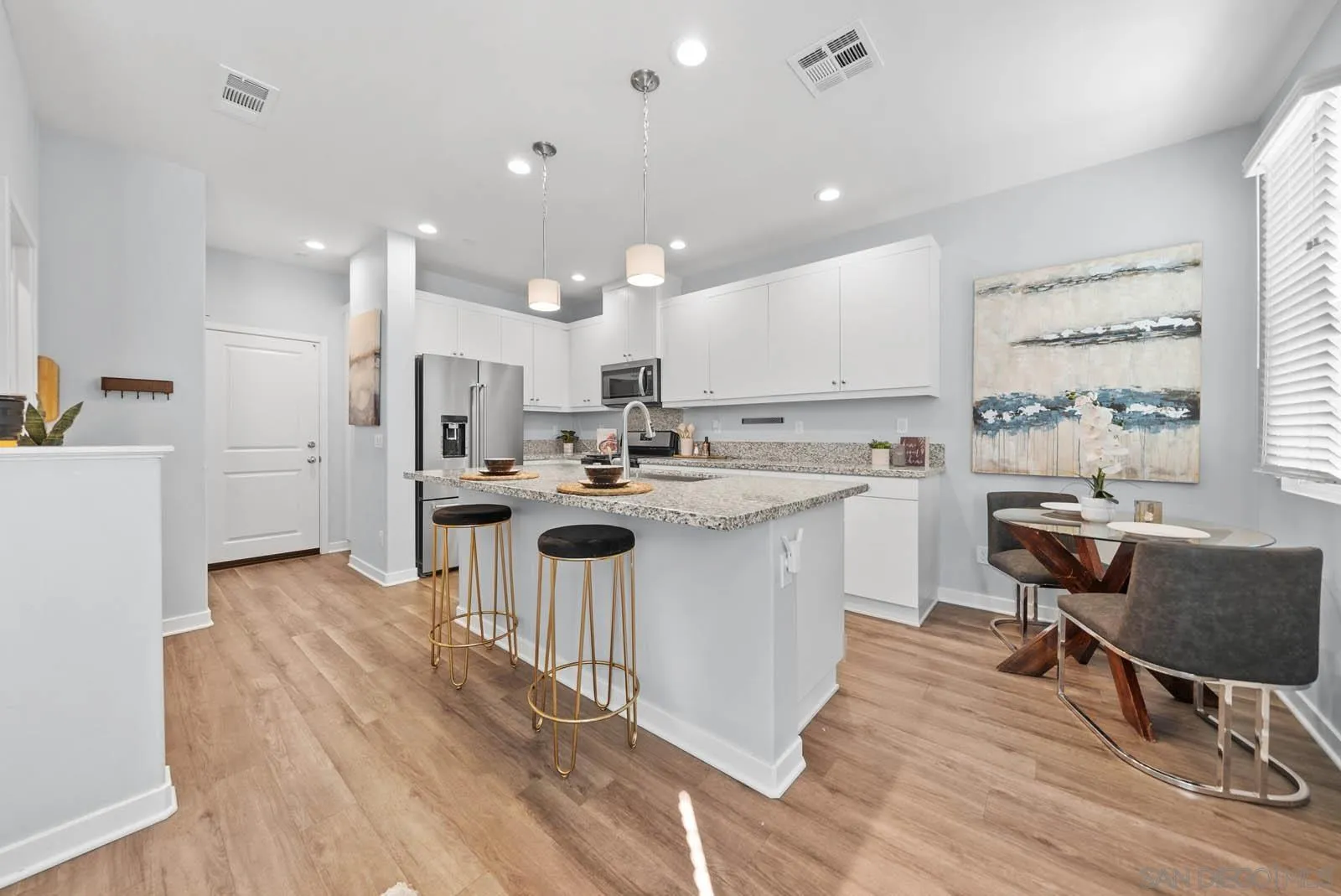 4132 Rio Azul Way Oceanside, CA 92057 - Photo 9 of 48 a kitchen with a sink a counter top space stainless steel appliances and a window