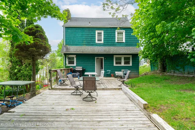 a view of a house with backyard sitting area and garden