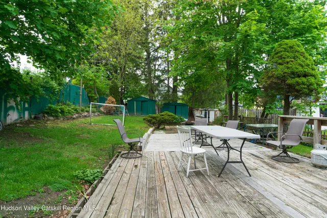 a view of a dinning tables and chairs in a yard