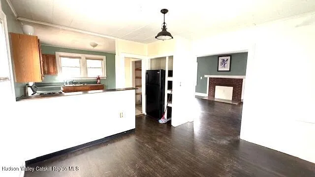 a view of a kitchen with wooden floor