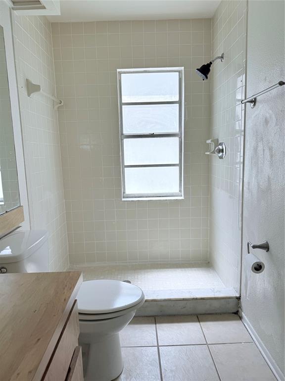 1636 Baker Road Lutz, FL 33559 - Photo 7 of 13 a bathroom with a granite countertop sink a toilet and shower