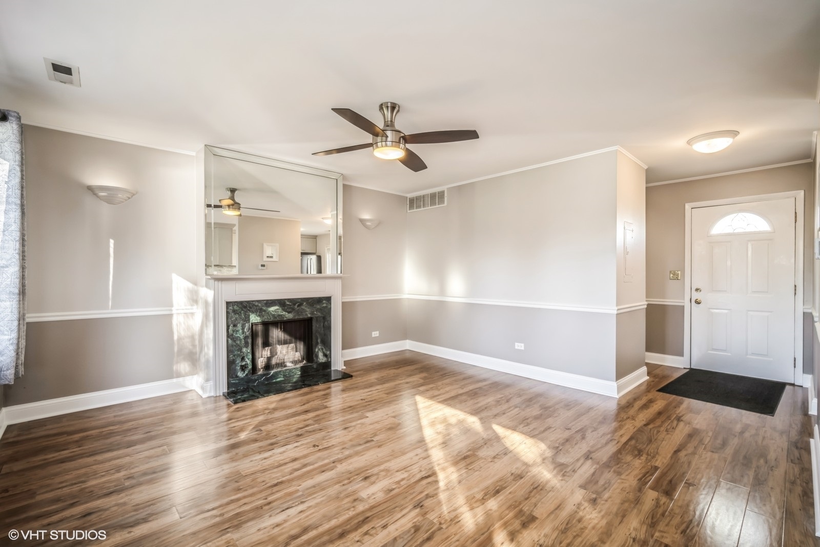793 Barnaby Place Wheeling, IL 60090 - Photo 6 of 10 a view of a livingroom with a fireplace a ceiling fan and wooden floor