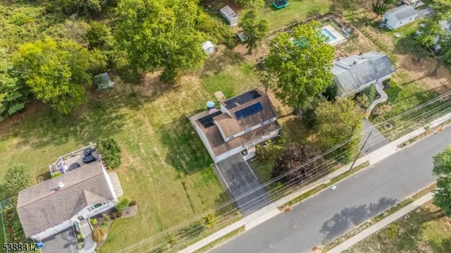 an aerial view of a house with a yard and lake view