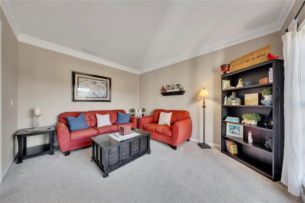 605 Garnet Court Canton, GA 30114 - Photo 11 of 75 a living room with furniture and a book shelf
