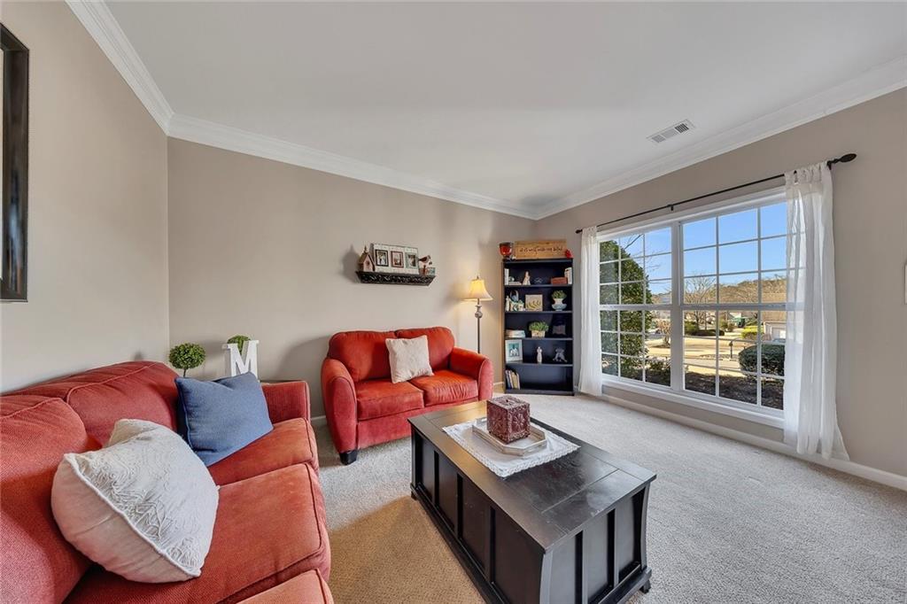 605 Garnet Court Canton, GA 30114 - Photo 12 of 75 a living room with furniture and a large window