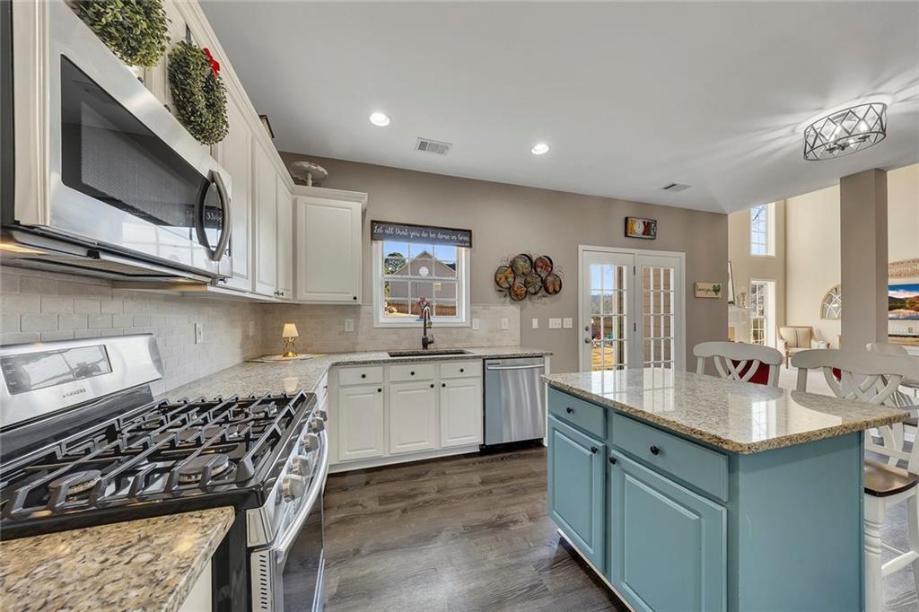 605 Garnet Court Canton, GA 30114 - Photo 22 of 75 a kitchen with a sink stove and microwave