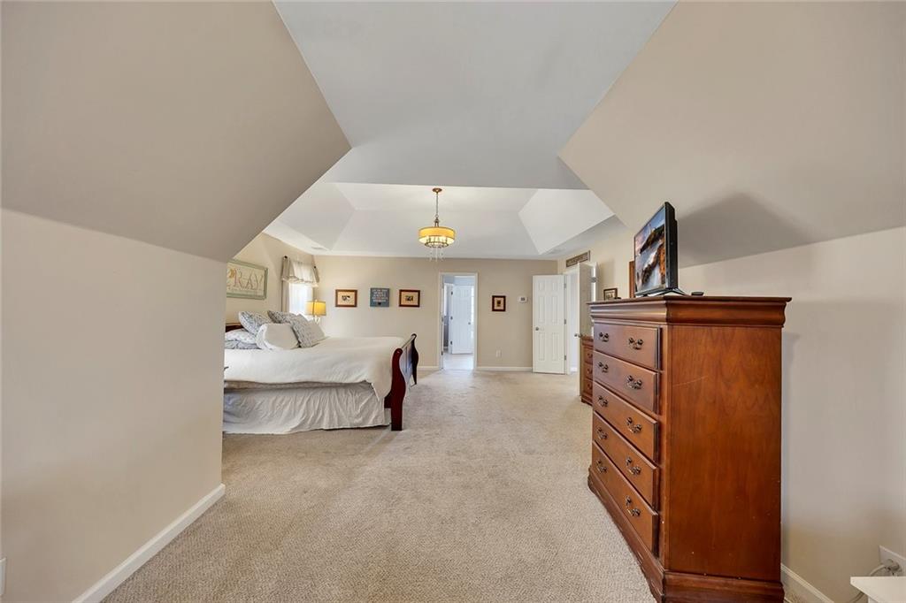 605 Garnet Court Canton, GA 30114 - Photo 33 of 75 a living room with furniture and a chandelier