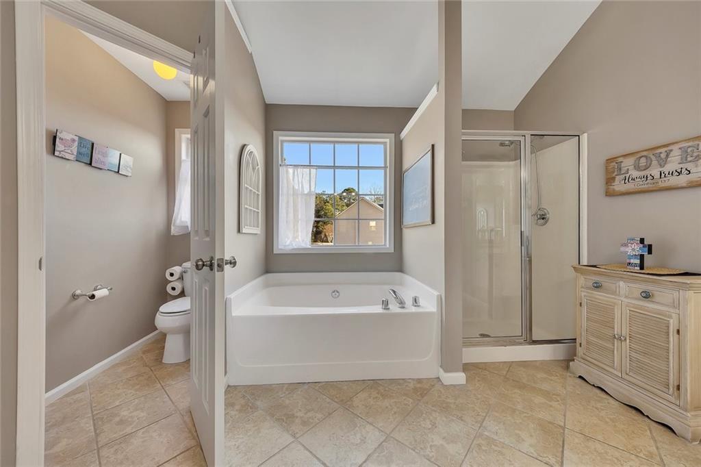 605 Garnet Court Canton, GA 30114 - Photo 35 of 75 a spacious bathroom with a tub shower and mirror