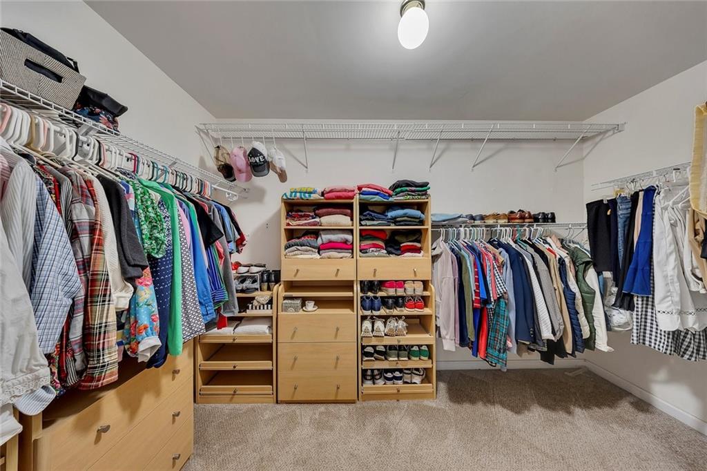 605 Garnet Court Canton, GA 30114 - Photo 38 of 75 a view of walk in closet with clothes