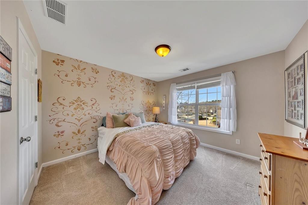 605 Garnet Court Canton, GA 30114 - Photo 42 of 75 a bedroom with a bed and a window