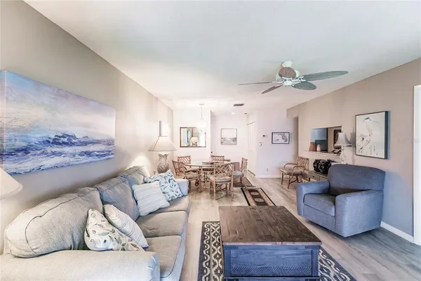 a living room with furniture and a ceiling fan