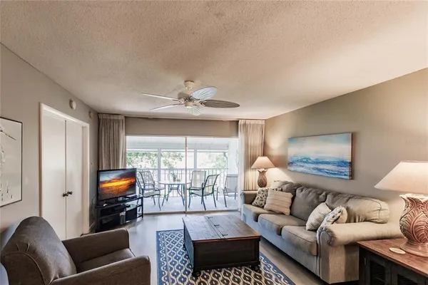 a living room with furniture couches and a flat screen tv