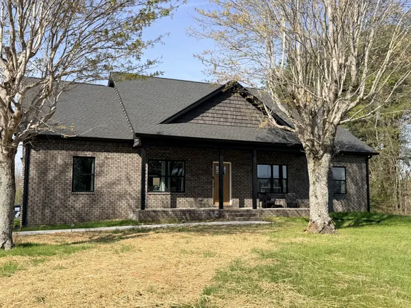 a view of a house with swimming pool and a porch with furniture