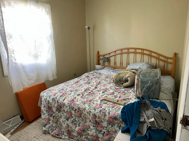 a bedroom with a bed and a window