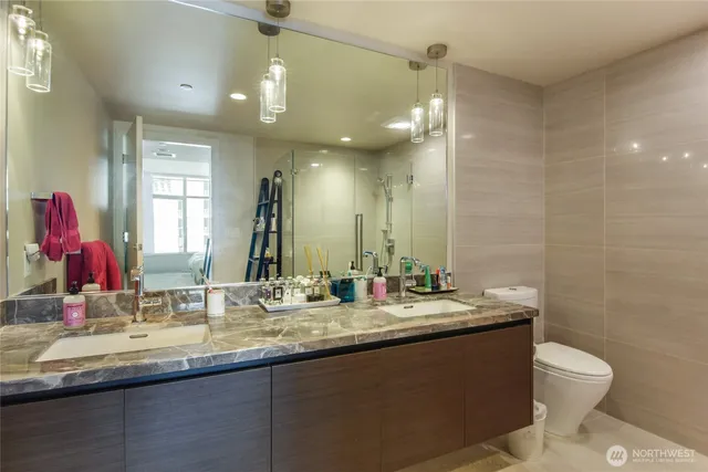 a bathroom with a sink double vanity and a mirror