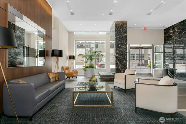a living room with furniture flat screen tv and a large window