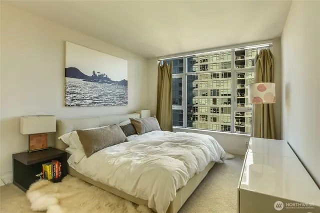 a spacious bedroom with a bed and wooden floor