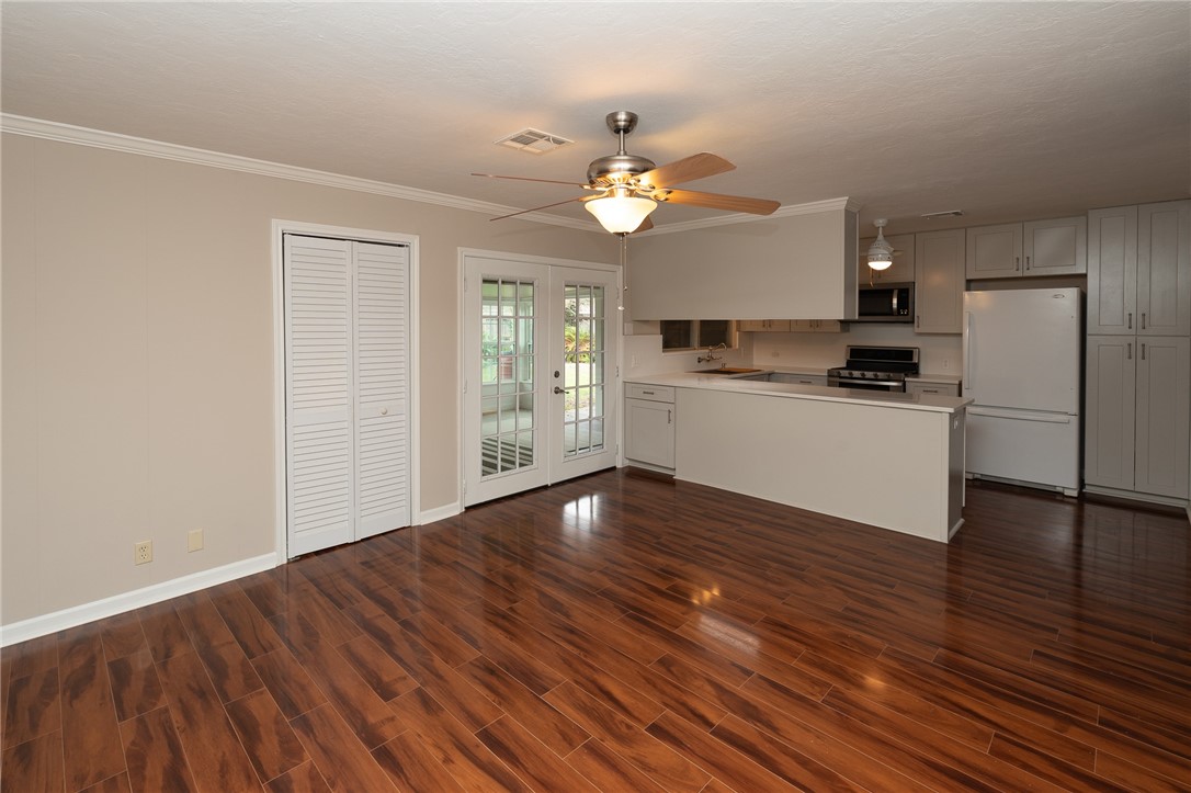 4213 Dolphin Place Corpus Christi, TX 78411 - Photo 9 of 27 a kitchen with a wooden floor and a refrigerator