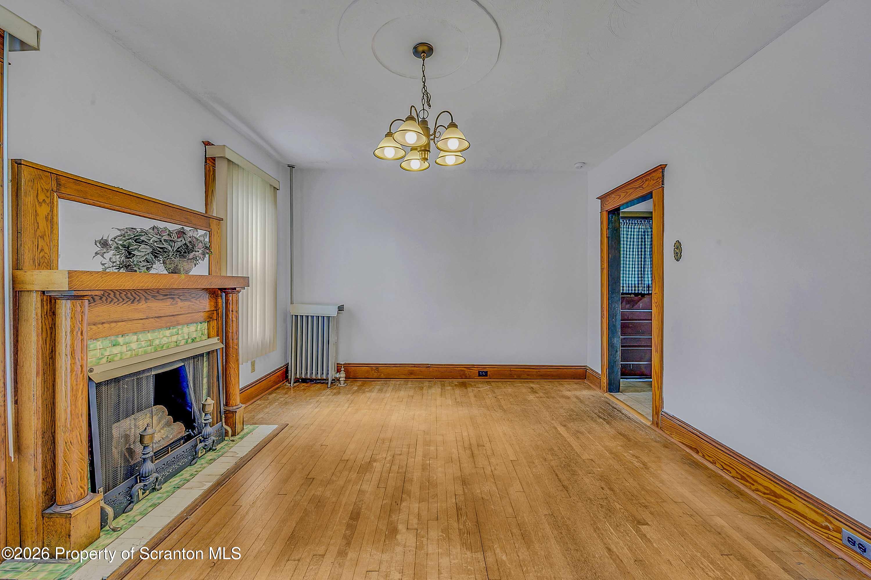 1425 Church Avenue Scranton, PA 18508 - Photo 9 of 21 a view of an empty room with a fireplace and a window