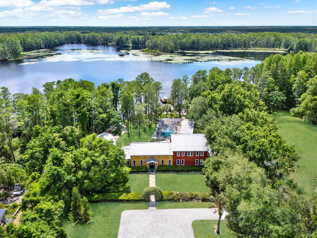 4541 School Road Land O' Lakes, FL 34638 - Photo 2 of 68 an aerial view of a house with a yard and lake view
