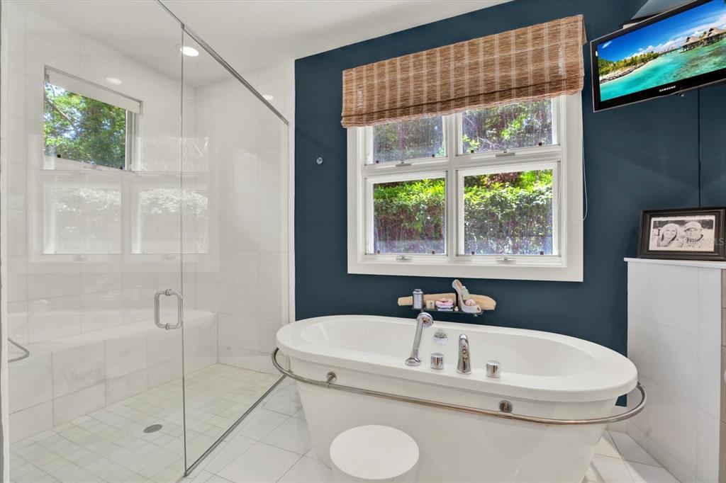 4541 School Road Land O' Lakes, FL 34638 - Photo 23 of 68 a white bath tub sitting next to a shower