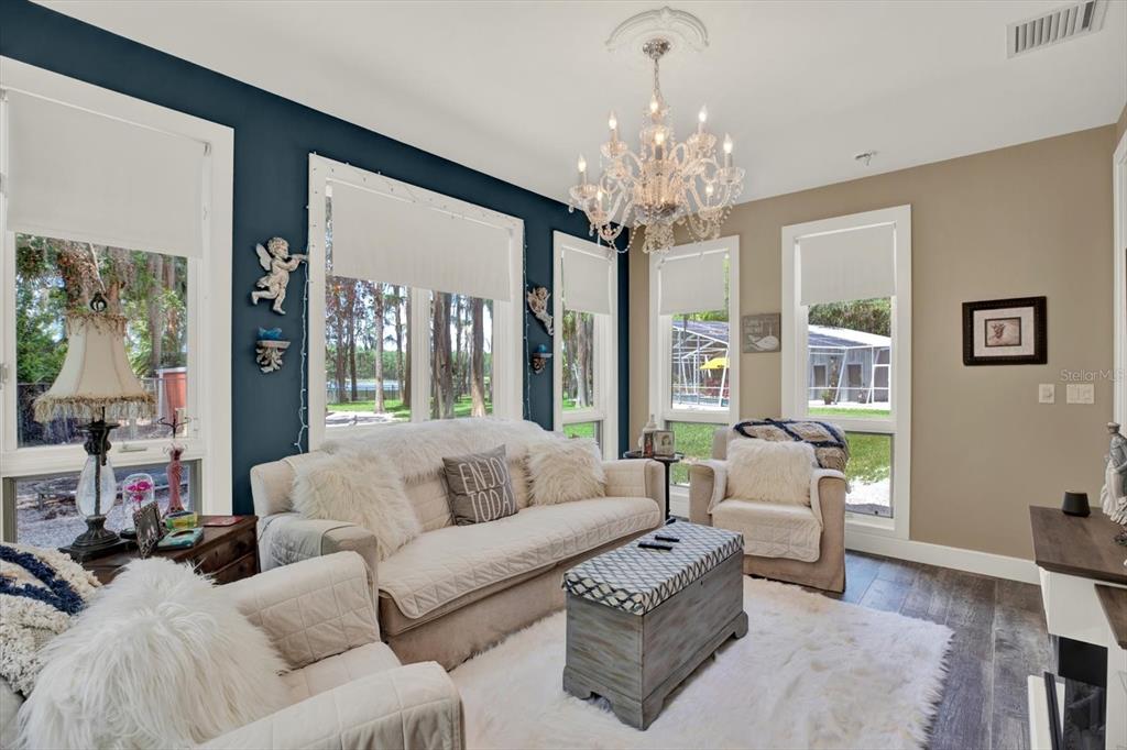4541 School Road Land O' Lakes, FL 34638 - Photo 24 of 68 a living room with furniture and a chandelier