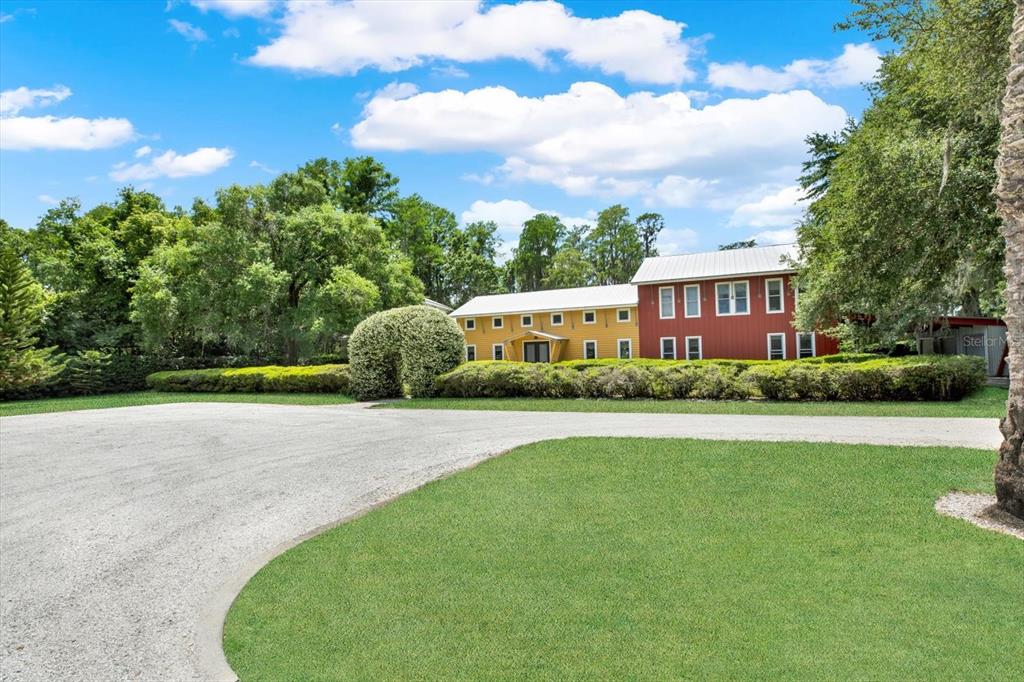 4541 School Road Land O' Lakes, FL 34638 - Photo 4 of 68 a front view of a house with a garden and yard