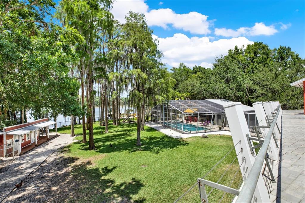 4541 School Road Land O' Lakes, FL 34638 - Photo 46 of 68 a view of a house with a backyard porch and sitting area