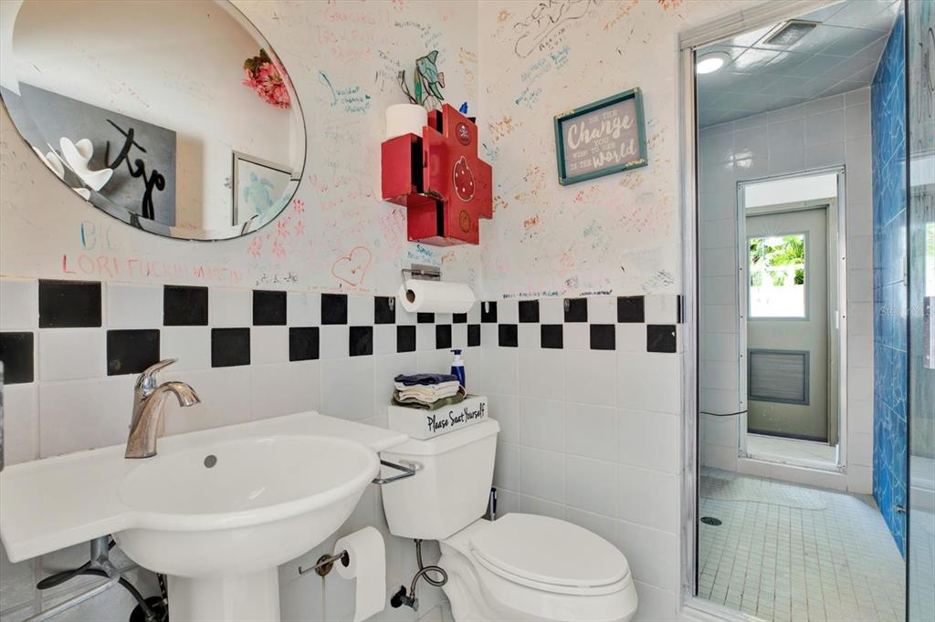 4541 School Road Land O' Lakes, FL 34638 - Photo 52 of 68 a bathroom with a sink a mirror a toilet and a shower