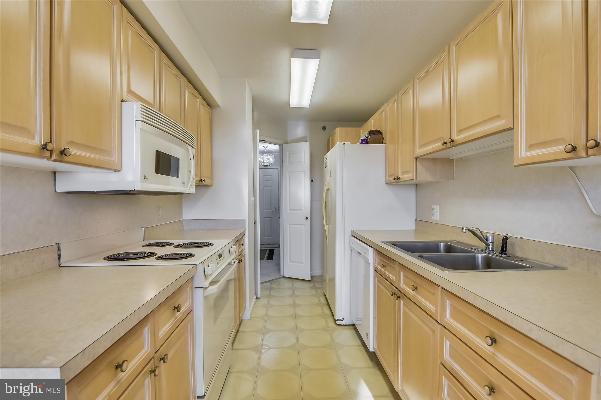 19385 Cypress Ridge Terrace, Unit 920 Leesburg, VA 20176 - Photo 11 of 42 a kitchen with stainless steel appliances granite countertop a sink and a stove